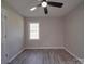 This bedroom has gray walls, wood-look floors, a ceiling fan, and a window at 3410 Nc 109 N Hwy, Wadesboro, NC 28170