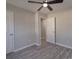 This bedroom has gray walls, wood-look floors, a ceiling fan, and two white doors at 3410 Nc 109 N Hwy, Wadesboro, NC 28170