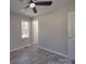 This bedroom has gray walls, wood-look floors, a ceiling fan, and a window at 3410 Nc 109 N Hwy, Wadesboro, NC 28170
