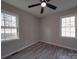 Bedroom with windows, light gray walls, and wood-look flooring at 3410 Nc 109 N Hwy, Wadesboro, NC 28170