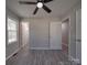 This bedroom has gray walls, wood-look floors, a ceiling fan, and doors at 3410 Nc 109 N Hwy, Wadesboro, NC 28170