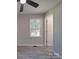 This bedroom has gray walls, wood-look floors, a ceiling fan, and a window at 3410 Nc 109 N Hwy, Wadesboro, NC 28170