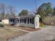 Charming single-story home featuring black shutters and a well-maintained front yard with a concrete driveway at 3410 Nc 109 N Hwy, Wadesboro, NC 28170
