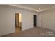 Large primary bedroom featuring neutral carpeting, tray ceiling, and ensuite bathroom at 3427 Secrest Lndg, Monroe, NC 28110