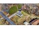 An aerial view of a well-maintained home featuring a gray roof, black shutters and a long gravel driveway at 3598 Puett Park Dr, Conover, NC 28613