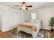 Cozy bedroom features a ceiling fan, plush bedding, hardwood floors, and a neutral color palette at 3598 Puett Park Dr, Conover, NC 28613