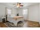 Bright bedroom with a ceiling fan, natural light, hardwood floors, and a comfortable bed with stylish bedding at 3598 Puett Park Dr, Conover, NC 28613