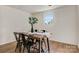 Well-lit dining room with natural light, hardwood floors, neutral walls, and a modern table set for four at 3598 Puett Park Dr, Conover, NC 28613