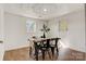 Bright dining room featuring hardwood floors, decoratively textured ceilings, and natural light from two windows at 3598 Puett Park Dr, Conover, NC 28613