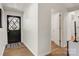 Bright entryway with hardwood floors, and a black front door with decorative glass panes at 3598 Puett Park Dr, Conover, NC 28613