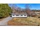 Charming single-story home with black shutters, gravel driveway, and partially dormant but well-maintained lawn at 3598 Puett Park Dr, Conover, NC 28613