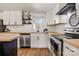 Modern kitchen with white cabinets, stainless steel appliances, and butcher block countertops at 3598 Puett Park Dr, Conover, NC 28613