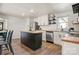 Well-lit kitchen featuring white cabinets, a stainless steel fridge, island, and modern appliances at 3598 Puett Park Dr, Conover, NC 28613