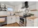 Modern kitchen with stainless steel appliances, white cabinets, and updated countertops at 3598 Puett Park Dr, Conover, NC 28613