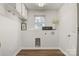 Bright laundry room with storage cabinets, hardwood floors, a window, and a laundry appliance hookups at 3598 Puett Park Dr, Conover, NC 28613