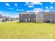 Lush green backyard view of a gray two-story home showcasing its manicured lawn and neighborhood setting at 4021 Eckels Dr, Charlotte, NC 28215