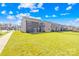 Expansive green backyard with a view of the home's gray exterior, sliding glass door, and neighborhood at 4021 Eckels Dr, Charlotte, NC 28215