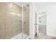 Bright bathroom showcasing a glass-enclosed tiled shower and an open doorway to a bedroom at 4021 Eckels Dr, Charlotte, NC 28215