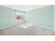 This cozy bedroom is painted green and has carpet and a window at 4021 Eckels Dr, Charlotte, NC 28215