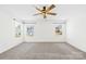 Spacious carpeted bedroom featuring a ceiling fan and large windows offering plenty of natural light at 4021 Eckels Dr, Charlotte, NC 28215