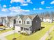 Aerial view of a two-story home featuring a well-manicured lawn, two-car garage and inviting front porch at 4021 Eckels Dr, Charlotte, NC 28215