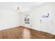 Bright living room with wood flooring, a large window, and a white front door at 4021 Eckels Dr, Charlotte, NC 28215