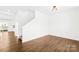 A bright living room with wood floors and white walls. Staircase is adjacent at 4021 Eckels Dr, Charlotte, NC 28215