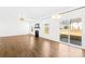 Bright living room with fireplace, wood floors, and sliding glass door at 4021 Eckels Dr, Charlotte, NC 28215