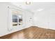 Bright living room with wood flooring, a large window, and a white front door at 4021 Eckels Dr, Charlotte, NC 28215