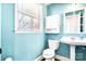 Bright bathroom with a pedestal sink, toilet, and a window providing natural light at 4025 4Th Street Nw Ln, Hickory, NC 28601