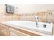 A luxurious soaking tub with decorative tile surround, inviting relaxation and spa-like comfort at 4025 4Th Street Nw Ln, Hickory, NC 28601