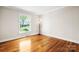 Sunny bedroom with hardwood floors, neutral paint, and a large window at 4025 4Th Street Nw Ln, Hickory, NC 28601