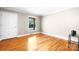 Empty bedroom with hardwood floors, a window, and neutral wall colors at 4025 4Th Street Nw Ln, Hickory, NC 28601