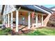 Covered patio with white columns, brick flooring, ceiling fans, and outdoor space at 4025 4Th Street Nw Ln, Hickory, NC 28601