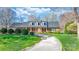 Beautiful brick home with a well-manicured lawn and a curved driveway at 4025 4Th Street Nw Ln, Hickory, NC 28601