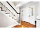 Bright foyer with hardwood floors, staircase and white front door at 4025 4Th Street Nw Ln, Hickory, NC 28601