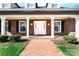 Charming brick home featuring a welcoming entryway with a brick walkway and well-kept landscaping at 4025 4Th Street Nw Ln, Hickory, NC 28601