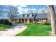 Inviting brick home featuring a covered front porch and lush green lawn at 4025 4Th Street Nw Ln, Hickory, NC 28601