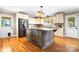 Well-appointed kitchen with a center island, stainless steel refrigerator, and tile backsplash at 4025 4Th Street Nw Ln, Hickory, NC 28601