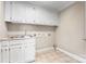 Functional laundry room with sink, cabinets, and tiled floors at 4025 4Th Street Nw Ln, Hickory, NC 28601