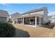 Expansive backyard with a covered patio, complete with an outdoor kitchen and a relaxing seating area at 4028 Shadowbrook Rd, Waxhaw, NC 28173