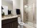 Bathroom with a granite countertop, dark wood vanity, and glass-enclosed shower at 4028 Shadowbrook Rd, Waxhaw, NC 28173