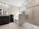 Bright bathroom with a glass-enclosed shower and separate tub under a window at 4028 Shadowbrook Rd, Waxhaw, NC 28173