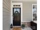 Close-up of the front door with wreath, lantern, and welcome mat at 4028 Shadowbrook Rd, Waxhaw, NC 28173