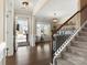 Elegant foyer with hardwood floors, staircase, and stylish bar area at 4028 Shadowbrook Rd, Waxhaw, NC 28173