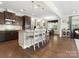 Open kitchen features granite countertops, an island with barstools, and stainless steel appliances at 4028 Shadowbrook Rd, Waxhaw, NC 28173