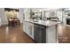 Kitchen with island, stainless steel dishwasher, and hardwood floors, with a view to the living and dining area at 4028 Shadowbrook Rd, Waxhaw, NC 28173