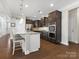 Kitchen with granite counters, an island with seating, stainless steel appliances, and hardwood floors at 4028 Shadowbrook Rd, Waxhaw, NC 28173