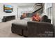 Living room with comfortable sectional seating, carpet flooring, and entertainment features at 4028 Shadowbrook Rd, Waxhaw, NC 28173