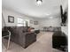Living room area with a sectional couch, ping pong table, and carpet flooring at 4028 Shadowbrook Rd, Waxhaw, NC 28173